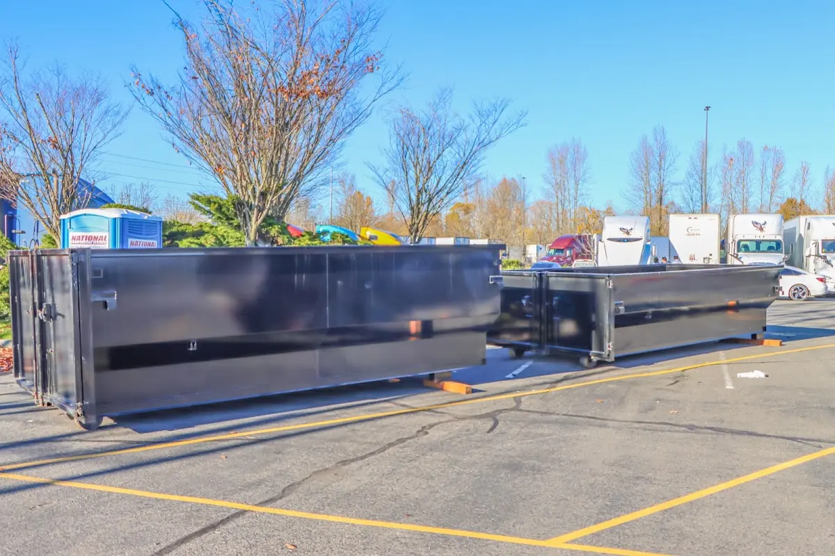 Professional dumpster rental service with roll-off container on residential driveway in Maize